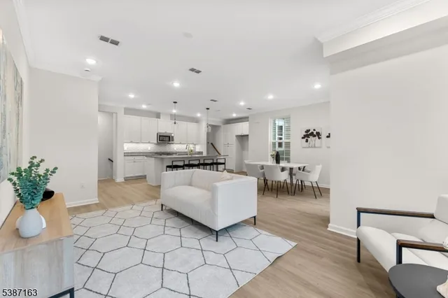 a dining room with furniture and wooden floor