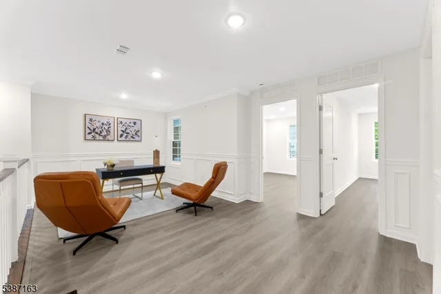 a living room with furniture and a chair