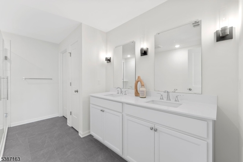 221 Myrtle Road Warren, NJ 07059 - Photo 24 of 37 a bathroom with a double vanity sink and a mirror