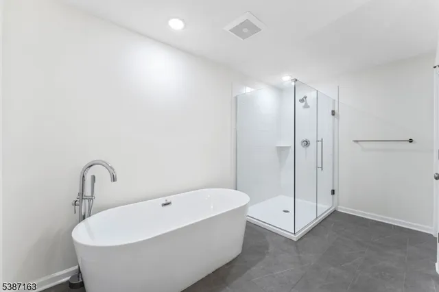a spacious bathroom with double sink and shower