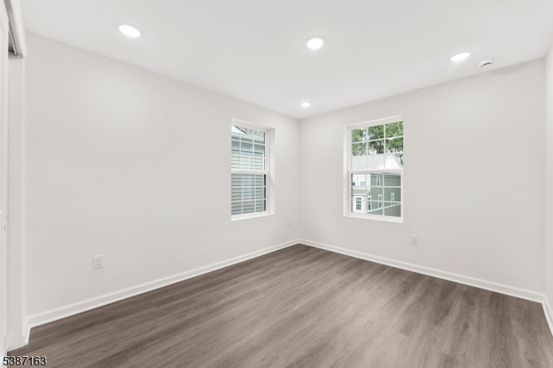 221 Myrtle Road Warren, NJ 07059 - Photo 27 of 37 an empty room with wooden floor and windows