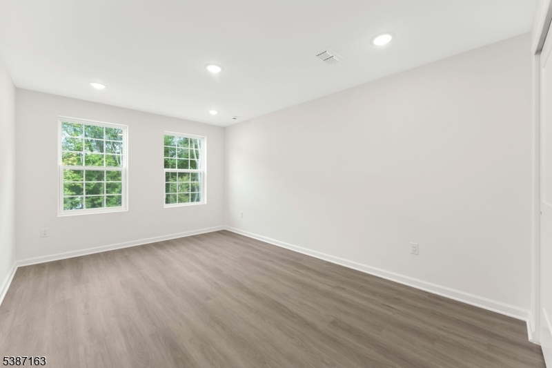 221 Myrtle Road Warren, NJ 07059 - Photo 29 of 37 an empty room with wooden floor and windows