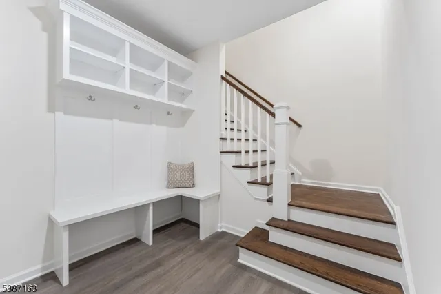 a view of entryway with wooden floor and stairs