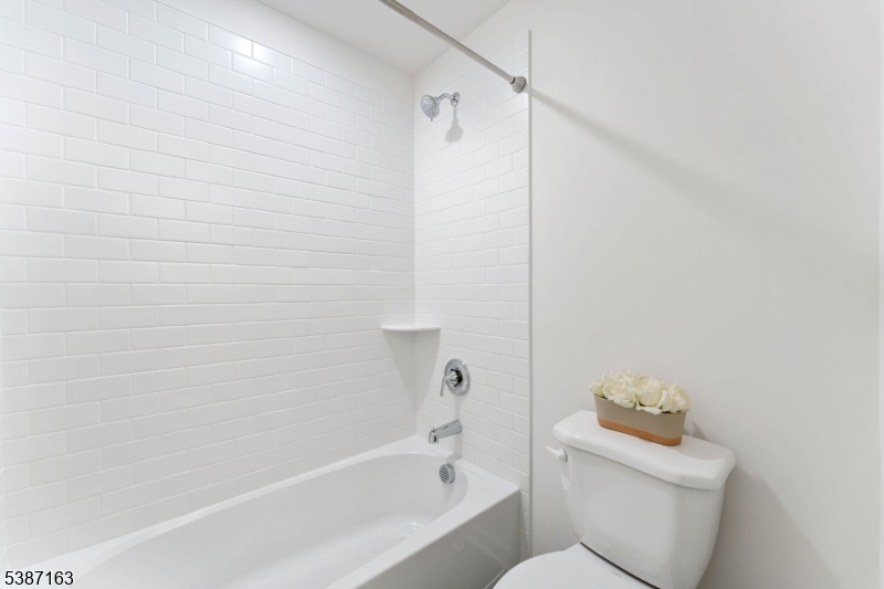 221 Myrtle Road Warren, NJ 07059 - Photo 32 of 37 a white bath tub sitting next to a toilet