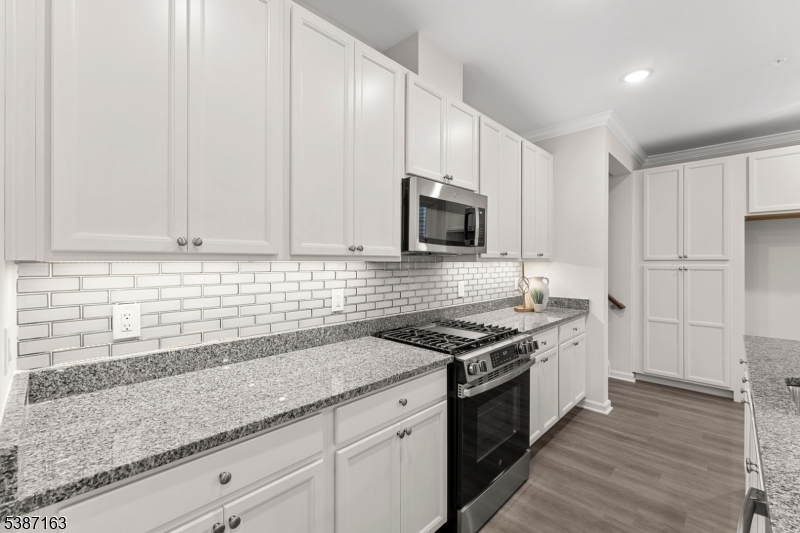 221 Myrtle Road Warren, NJ 07059 - Photo 7 of 37 a kitchen with stainless steel appliances granite countertop a sink stove and cabinets