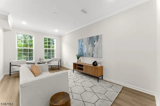a living room with furniture and large window