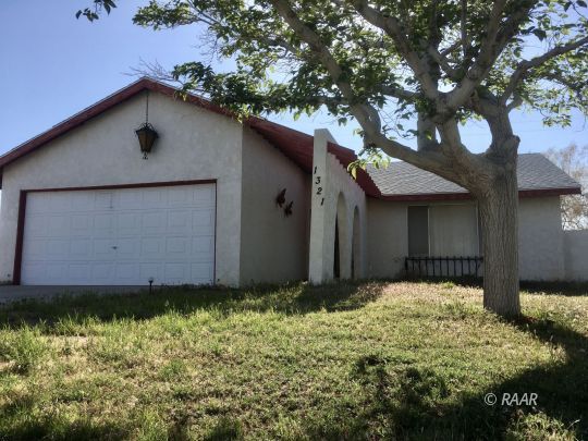 1321 South McCall Street Ridgecrest, CA 93555 - Photo 1 of 23 a front view of a house with a yard