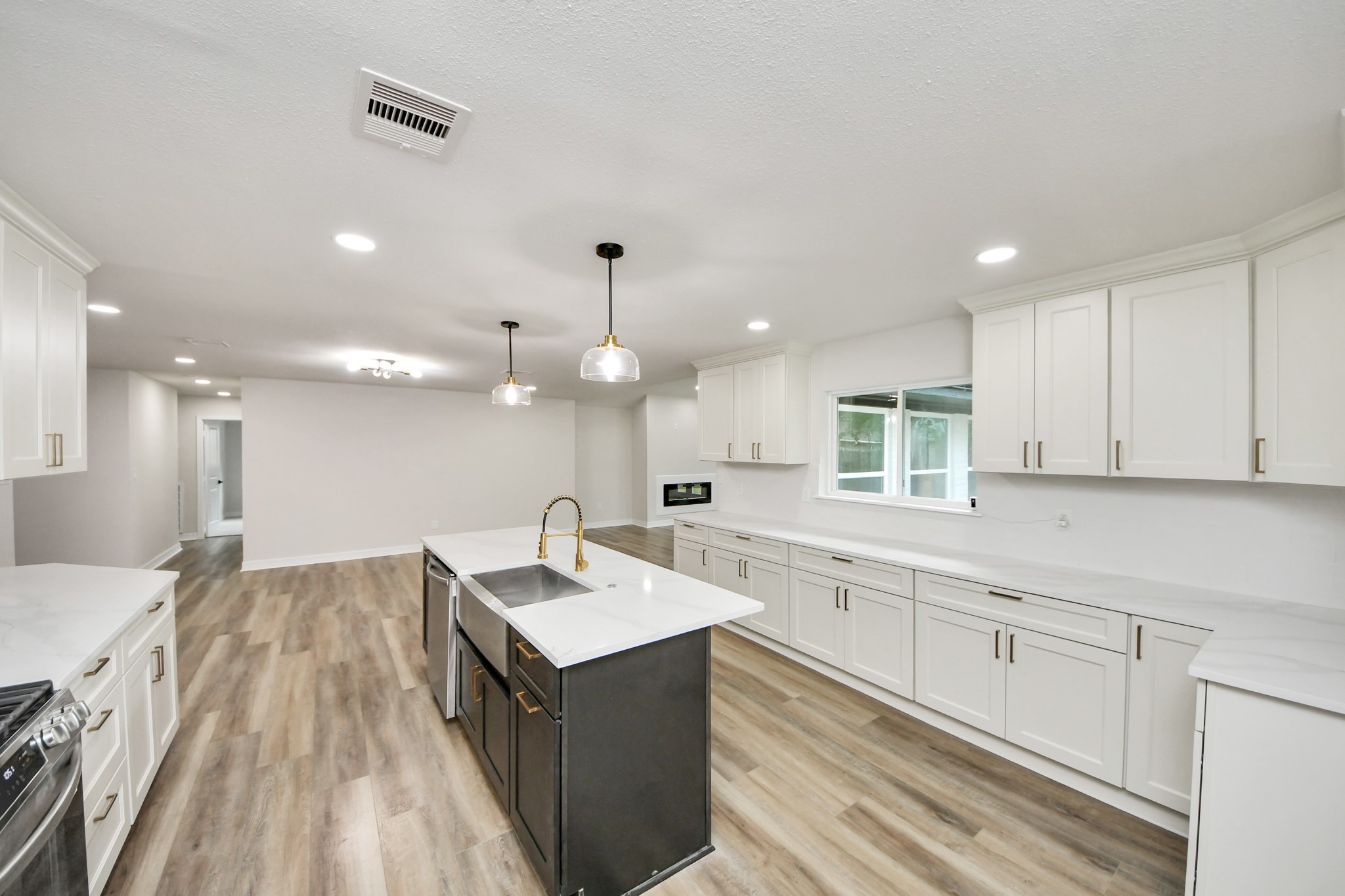 4311 Goldfinch Street Houston, TX 77035 - Photo 17 of 40 a large kitchen with a sink a counter top space stainless steel appliances and a window
