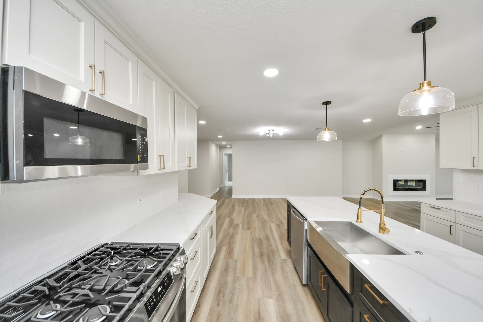 4311 Goldfinch Street Houston, TX 77035 - Photo 18 of 40 a kitchen with a sink and a stove top oven with wooden floor