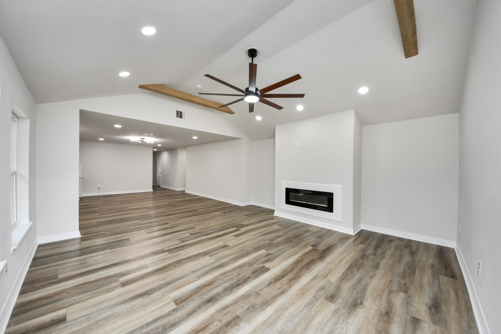 4311 Goldfinch Street Houston, TX 77035 - Photo 22 of 40 a view of a room with a ceiling fan and wooden floor