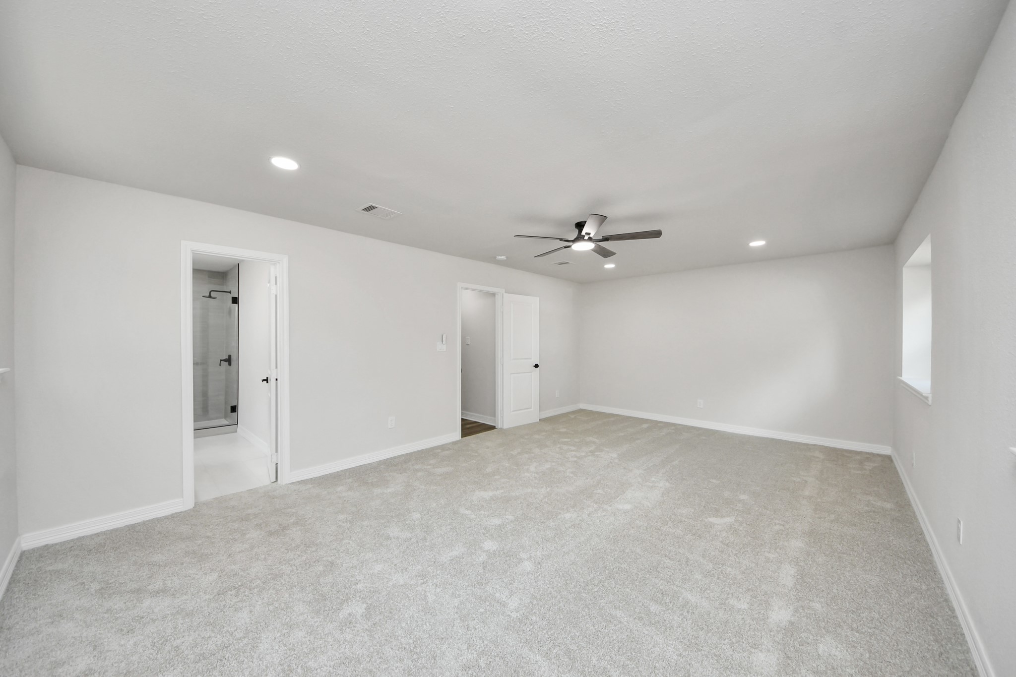4311 Goldfinch Street Houston, TX 77035 - Photo 27 of 40 an empty room with a ceiling fan and a window
