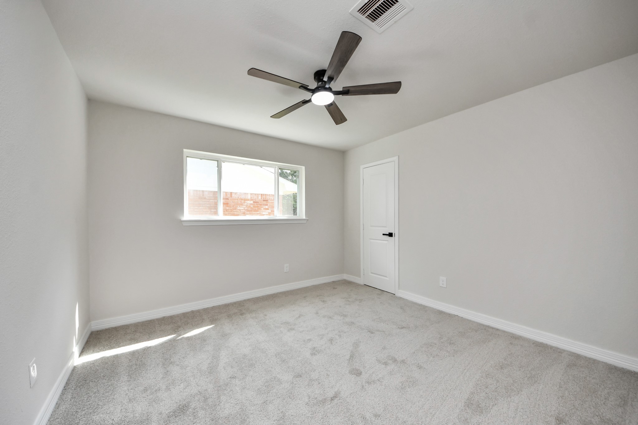 4311 Goldfinch Street Houston, TX 77035 - Photo 31 of 40 an empty room with windows and fan