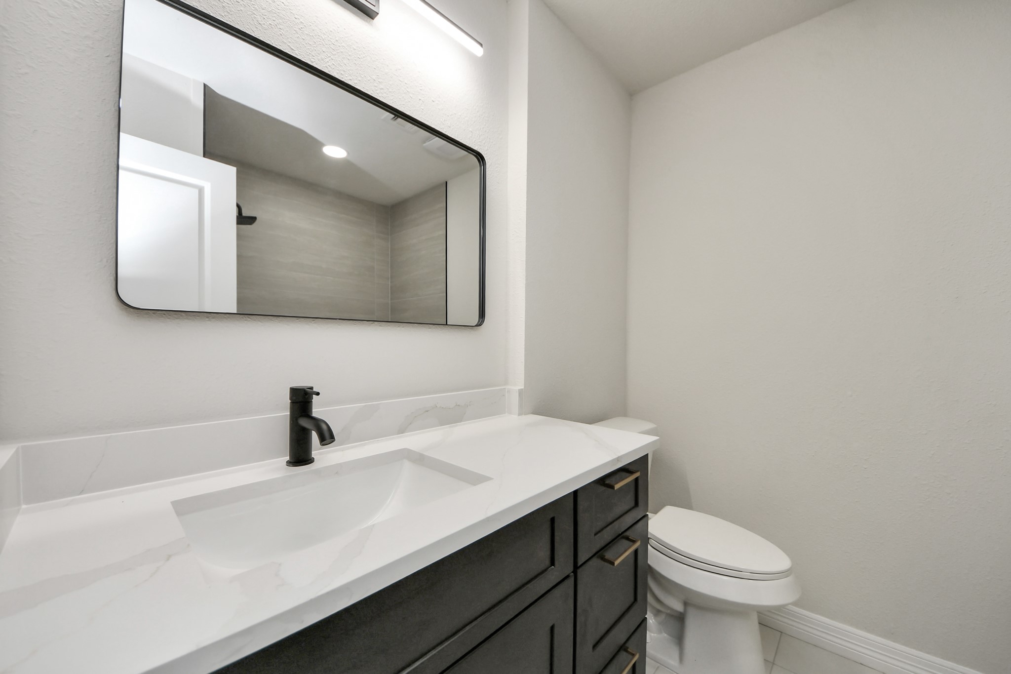 4311 Goldfinch Street Houston, TX 77035 - Photo 33 of 40 a bathroom with a sink a toilet and mirror