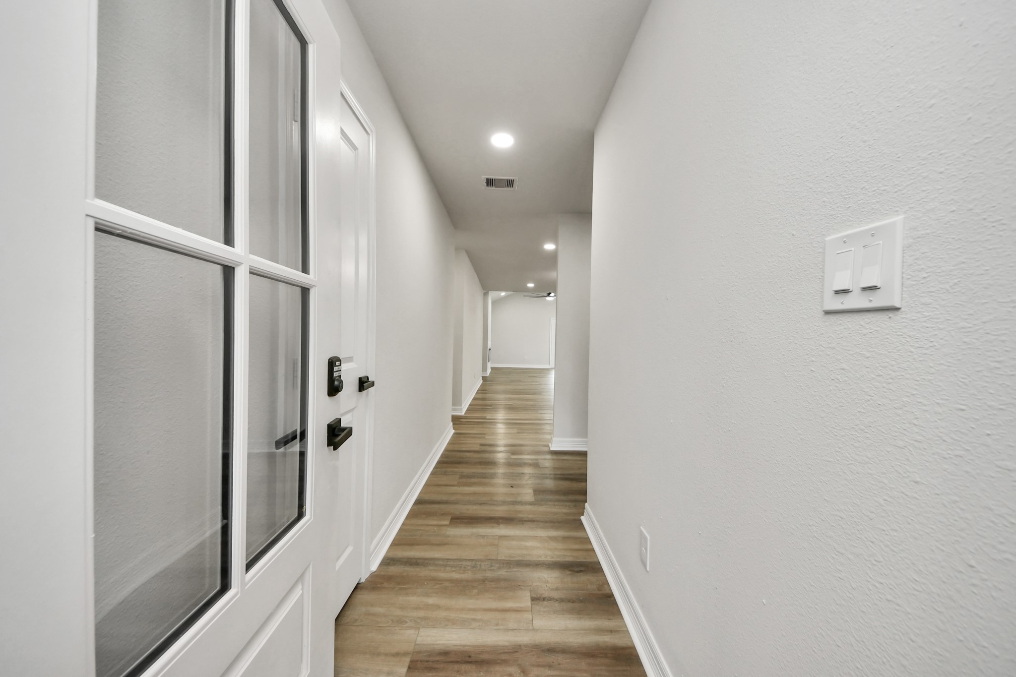 4311 Goldfinch Street Houston, TX 77035 - Photo 5 of 40 a view of a hallway with wooden floor and staircase