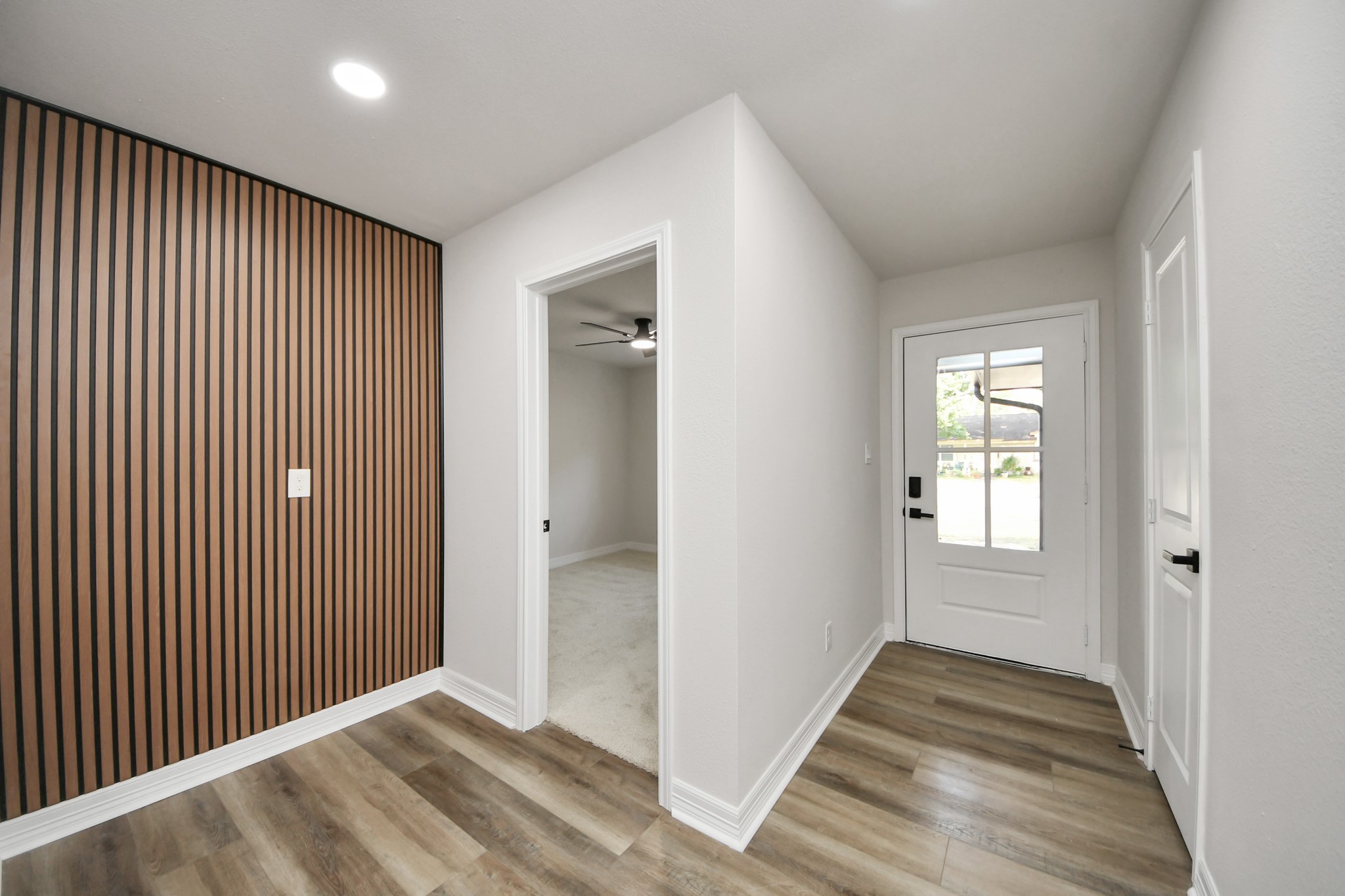 4311 Goldfinch Street Houston, TX 77035 - Photo 6 of 40 a view of an empty room with wooden floor and a window