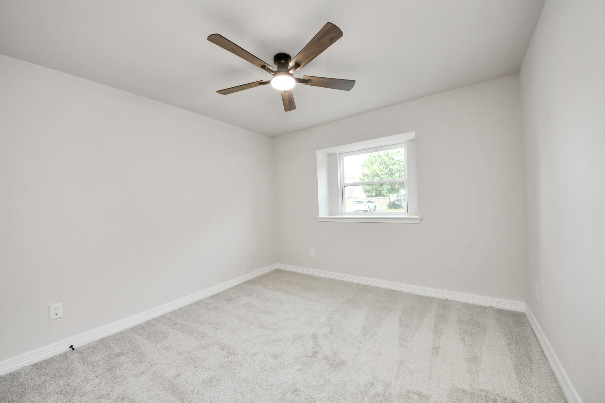 4311 Goldfinch Street Houston, TX 77035 - Photo 7 of 40 an empty room with a window and a fan