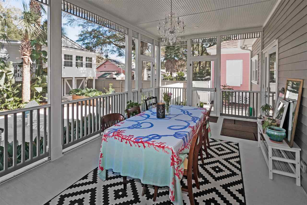 28 Rohde Avenue St. Augustine, FL 32084 - Photo 41 of 48 a dining room with furniture a chandelier and flat screen tv