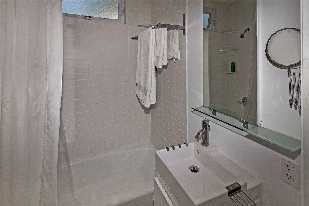 28 Rohde Avenue St. Augustine, FL 32084 - Photo 43 of 48 a bathroom with a granite countertop sink a mirror and shower
