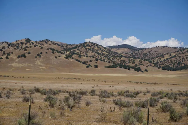 a front view of a house with entryway and outdoor seating