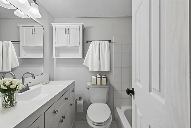 a bathroom with a sink toilet and shower