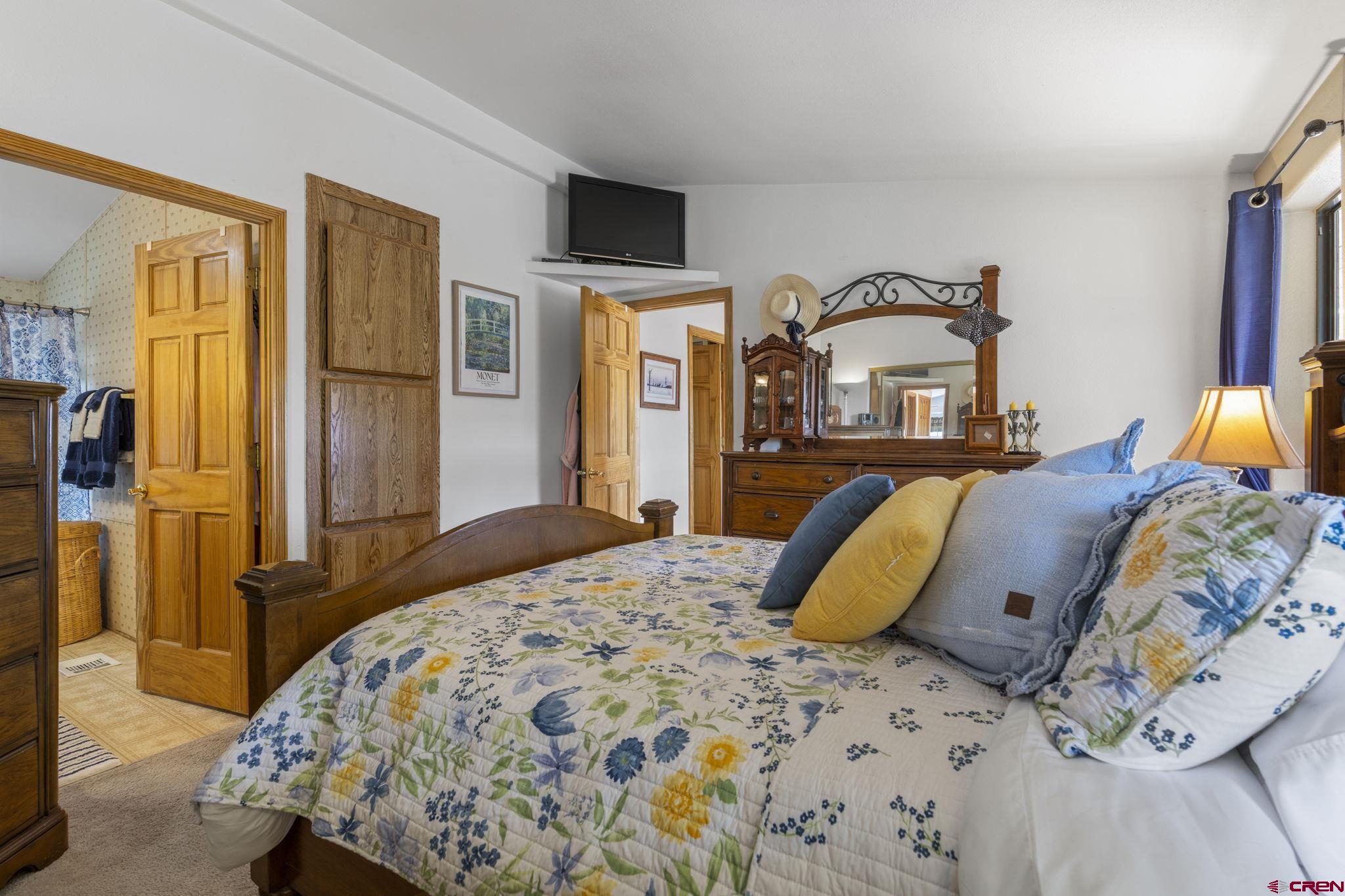 45 Pine Ridge Road Durango, CO 81301 - Photo 22 of 44 a bedroom with a bed and wooden floor