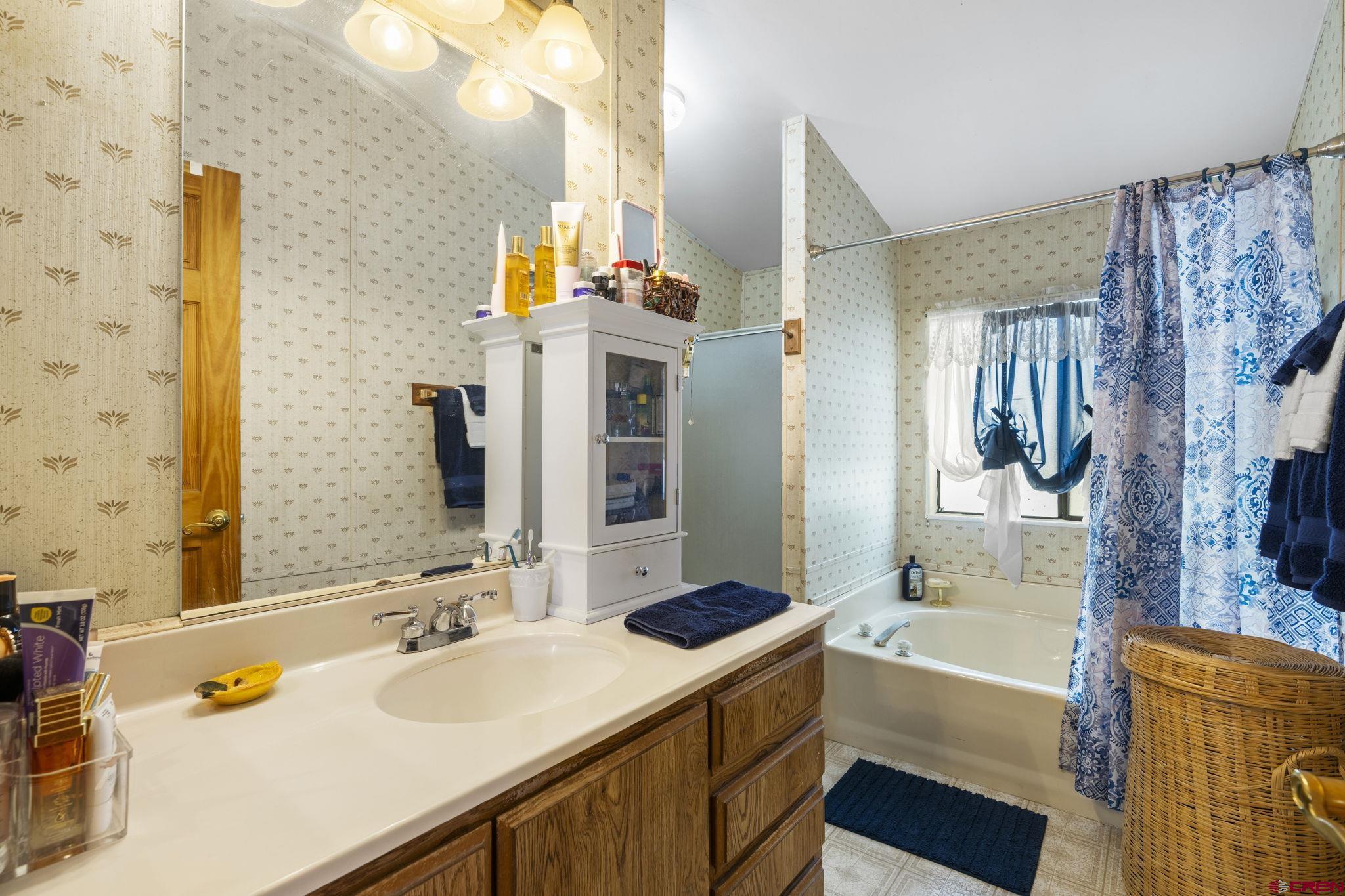 45 Pine Ridge Road Durango, CO 81301 - Photo 25 of 44 a bathroom with a tub sink and mirror