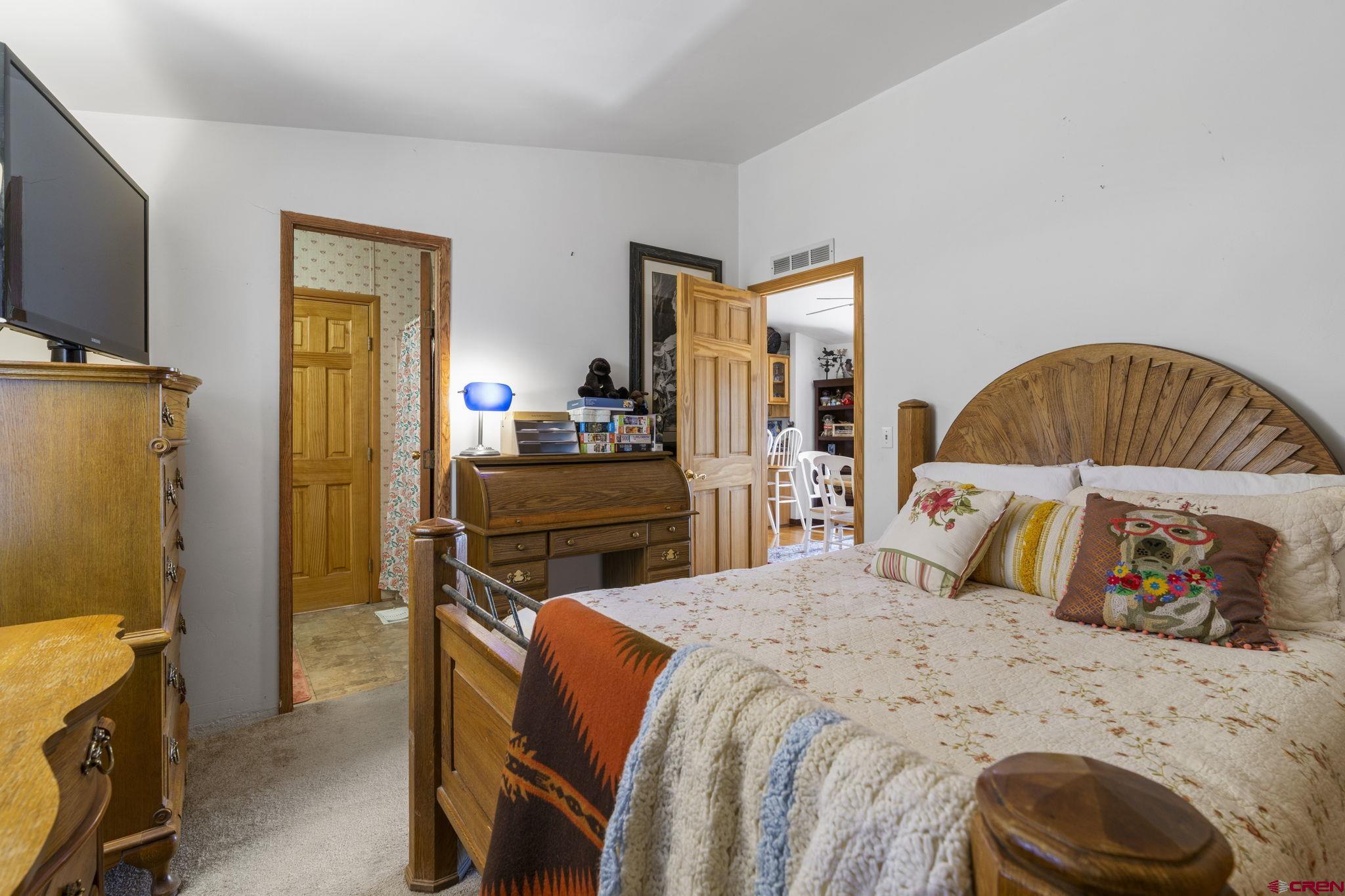 45 Pine Ridge Road Durango, CO 81301 - Photo 27 of 44 a bedroom with a bed and a tv