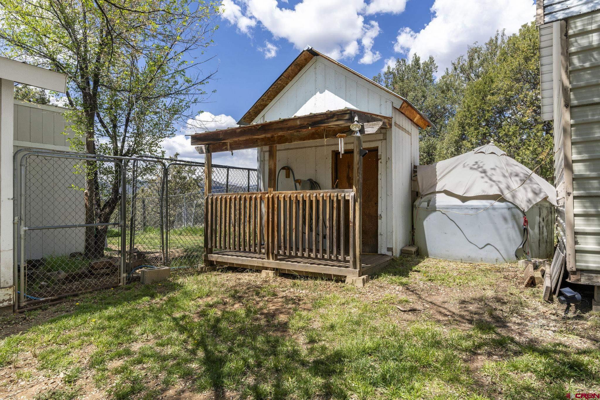 45 Pine Ridge Road Durango, CO 81301 - Photo 31 of 44 a view of a house with a small yard and wooden fence