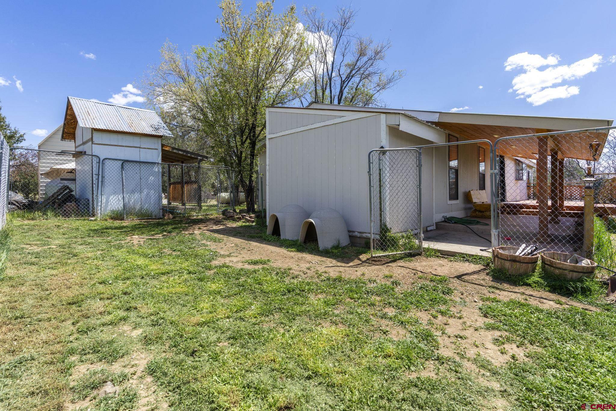 45 Pine Ridge Road Durango, CO 81301 - Photo 36 of 44 a backyard of a house with yard and outdoor seating