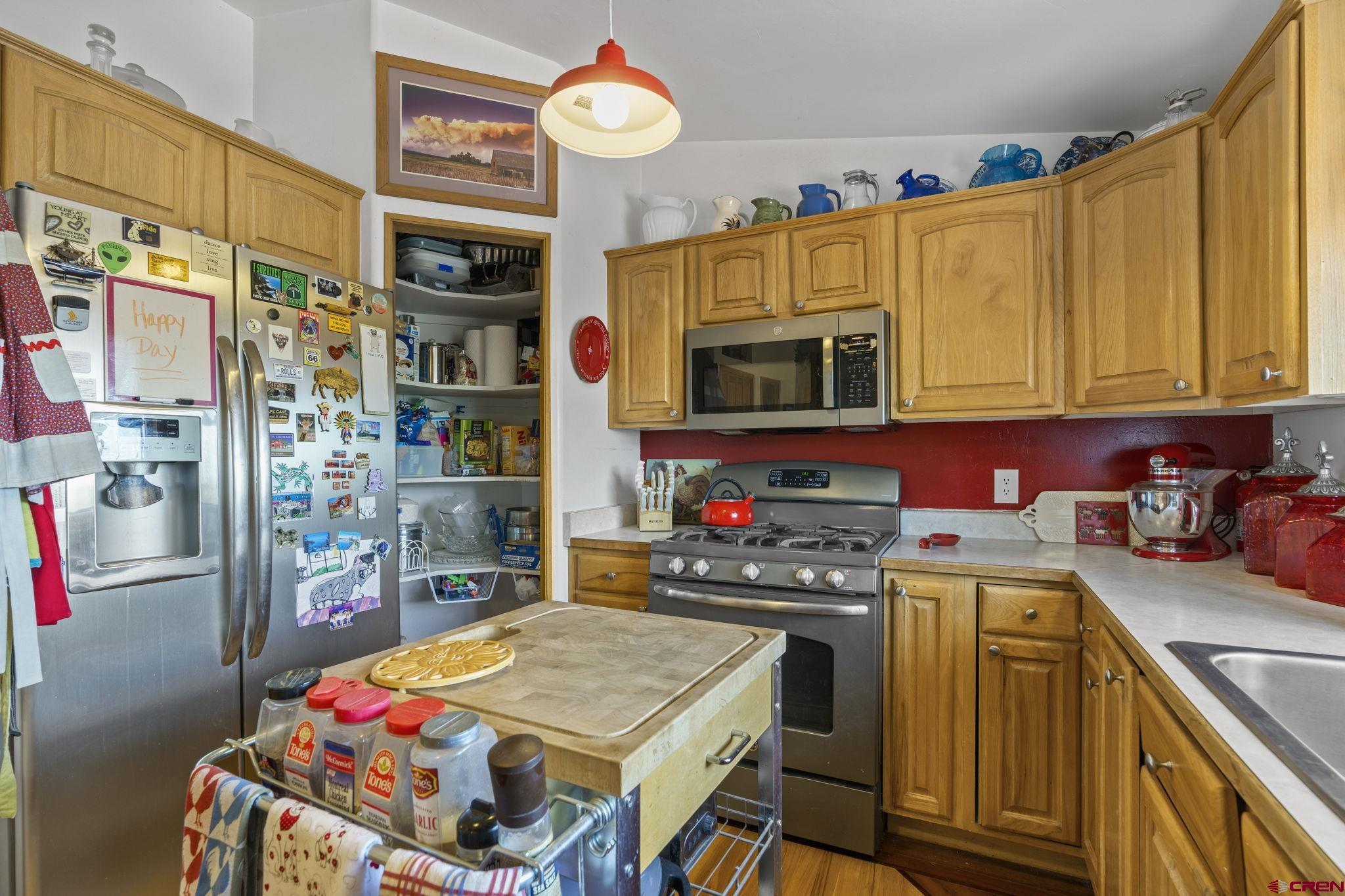 45 Pine Ridge Road Durango, CO 81301 - Photo 7 of 44 a kitchen with stainless steel appliances a stove a sink dishwasher and cabinets with wooden floor