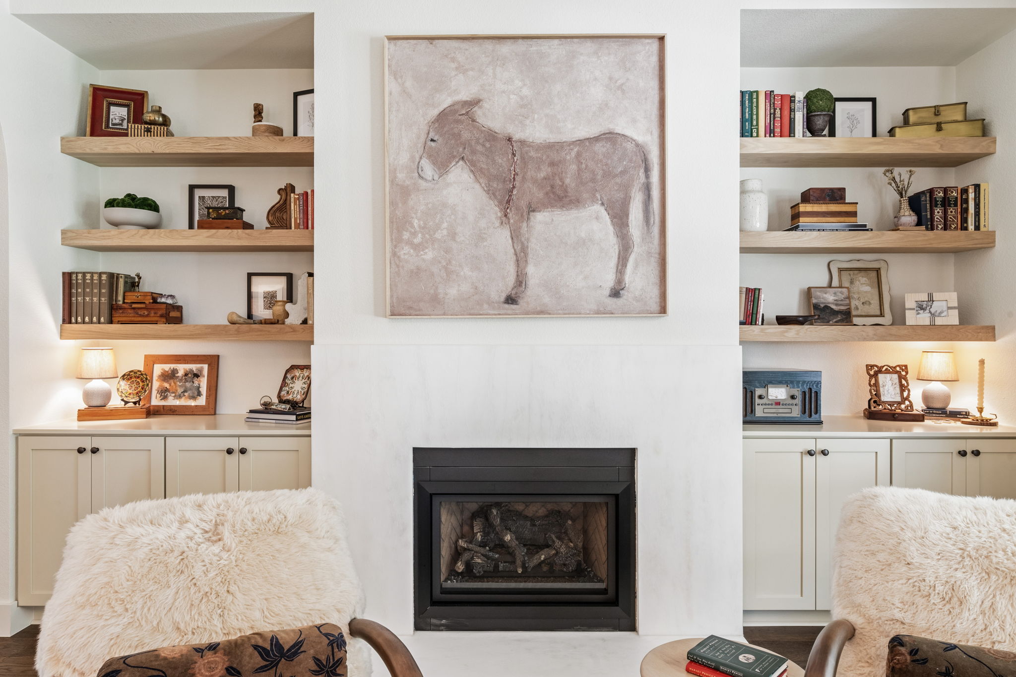 118 Cold Springs Drive Georgetown, TX 78633 - Photo 6 of 40 A well-appointed living area boasts a sleek fireplace framed by built-in shelving, offering both warmth and sophisticated storage.