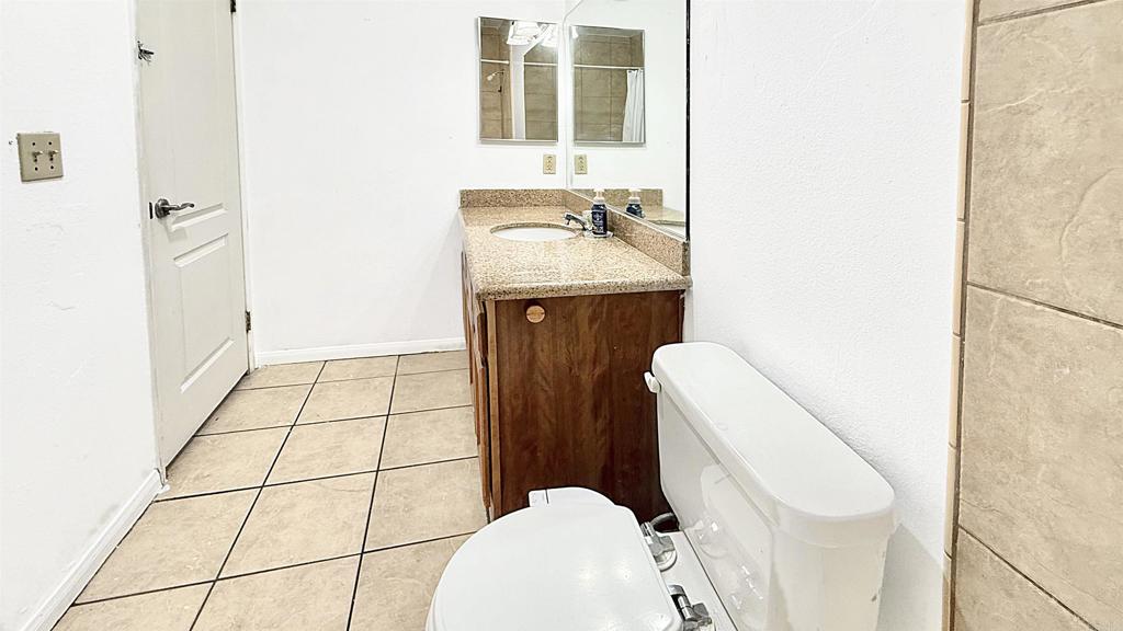 10235 Madrid Way, Unit 114 Spring Valley, CA 91977 - Photo 14 of 26 a bathroom with a sink a toilet and mirror