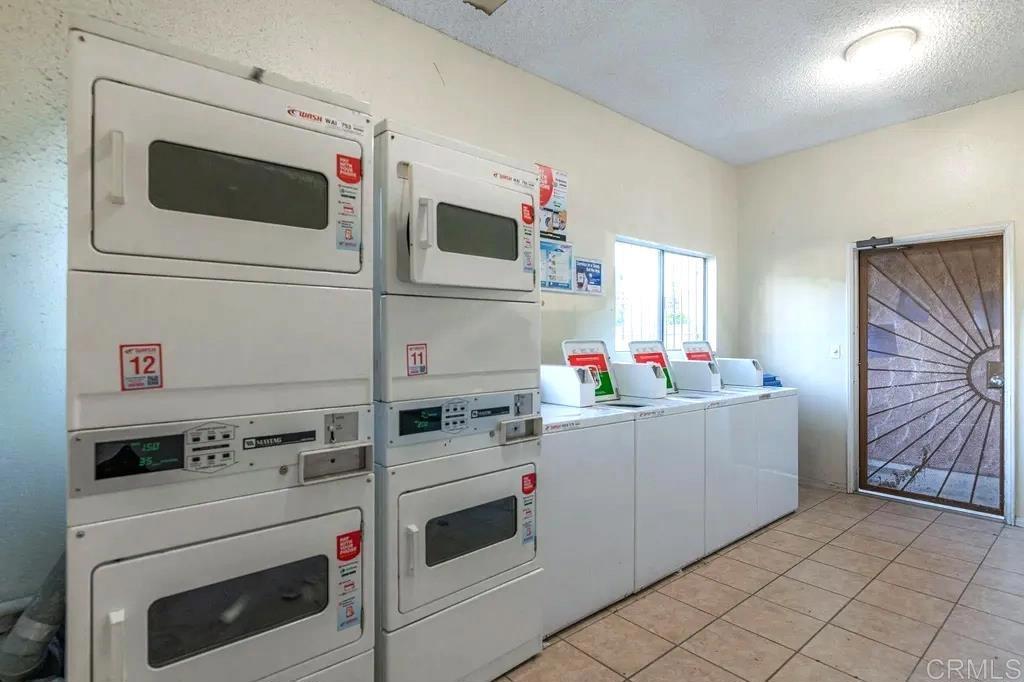 10235 Madrid Way, Unit 114 Spring Valley, CA 91977 - Photo 17 of 26 a kitchen with cabinets and white appliances