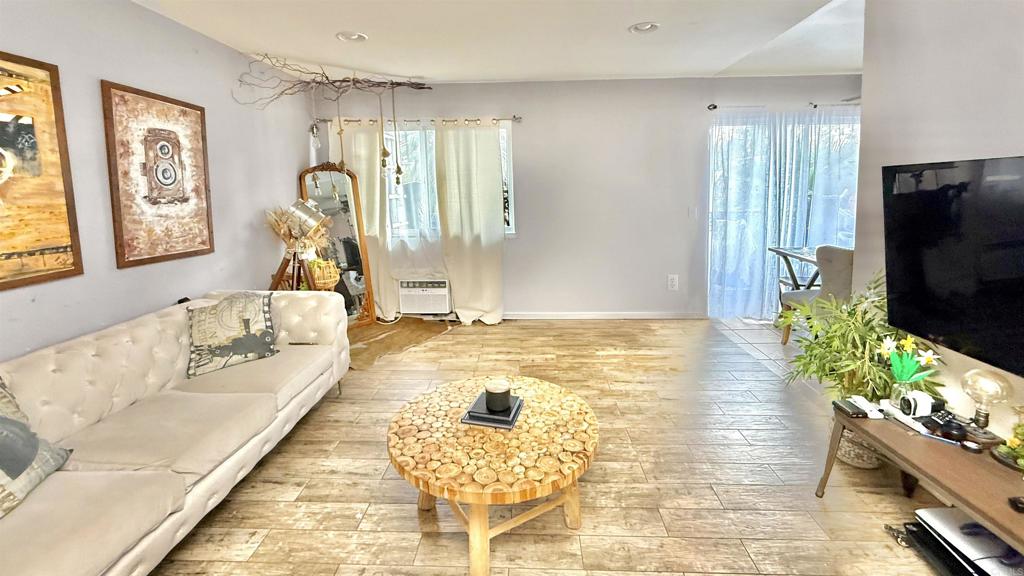 10235 Madrid Way, Unit 114 Spring Valley, CA 91977 - Photo 2 of 26 a living room with furniture and a flat screen tv