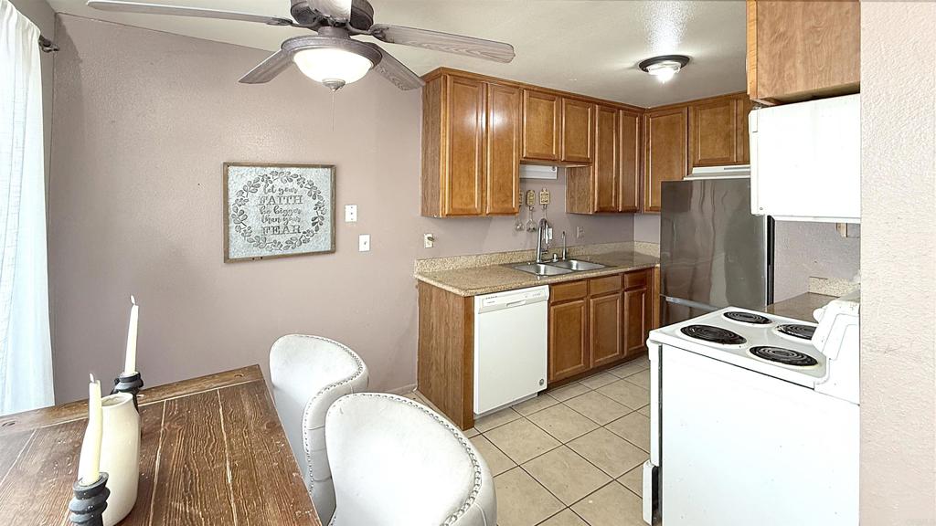 10235 Madrid Way, Unit 114 Spring Valley, CA 91977 - Photo 6 of 26 a kitchen with sink cabinets and window