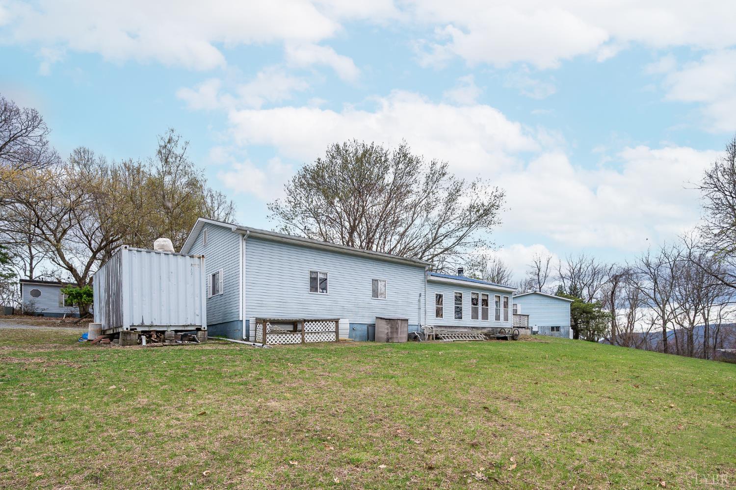 4400 Murray Hollow Road Thaxton, VA 24174 - Photo 7 of 56 a view of a house with a big yard and large trees