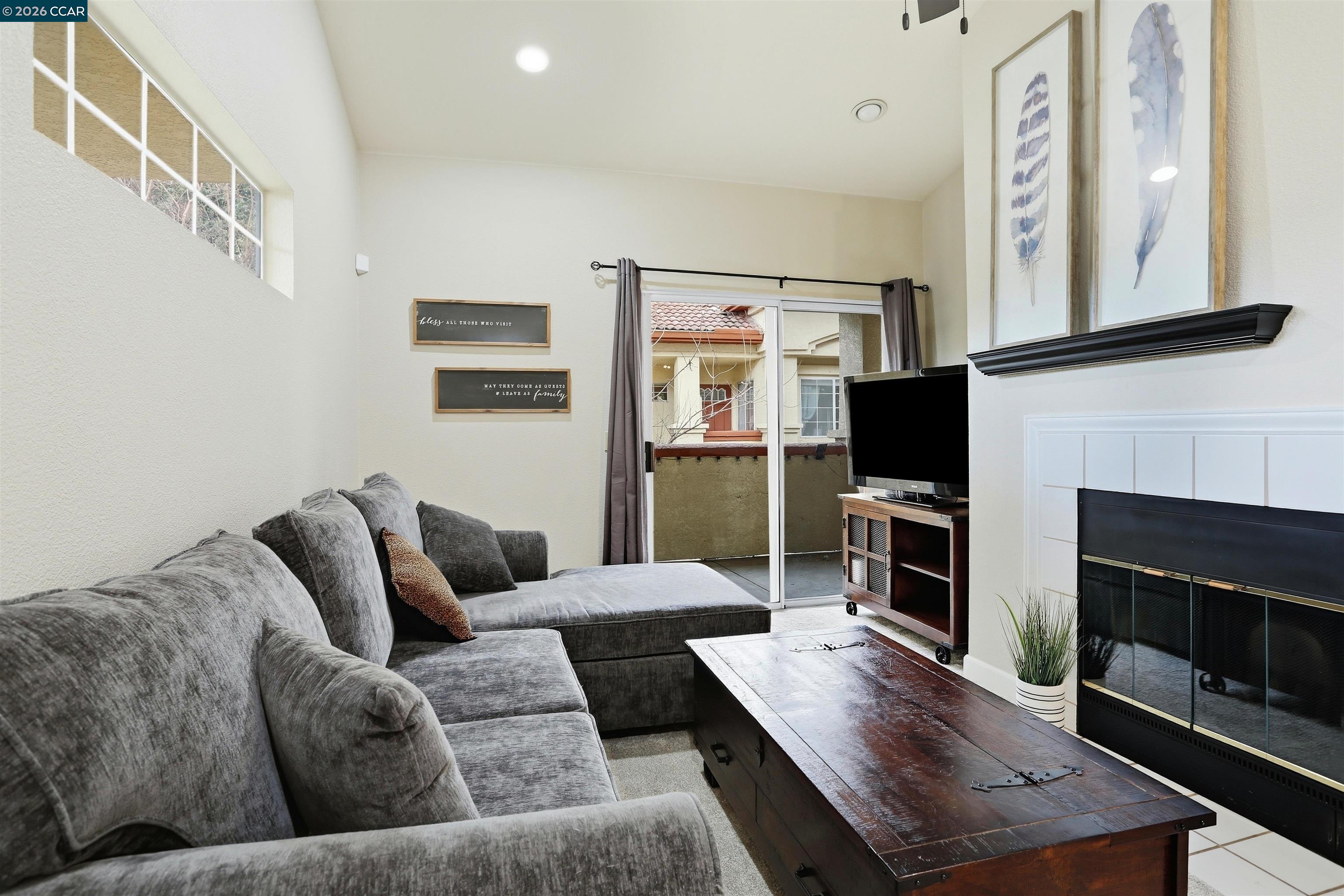 7020 Stagecoach Road, Unit G Dublin, CA 94568 - Photo 13 of 21 a living room with furniture a flat screen tv and a fireplace