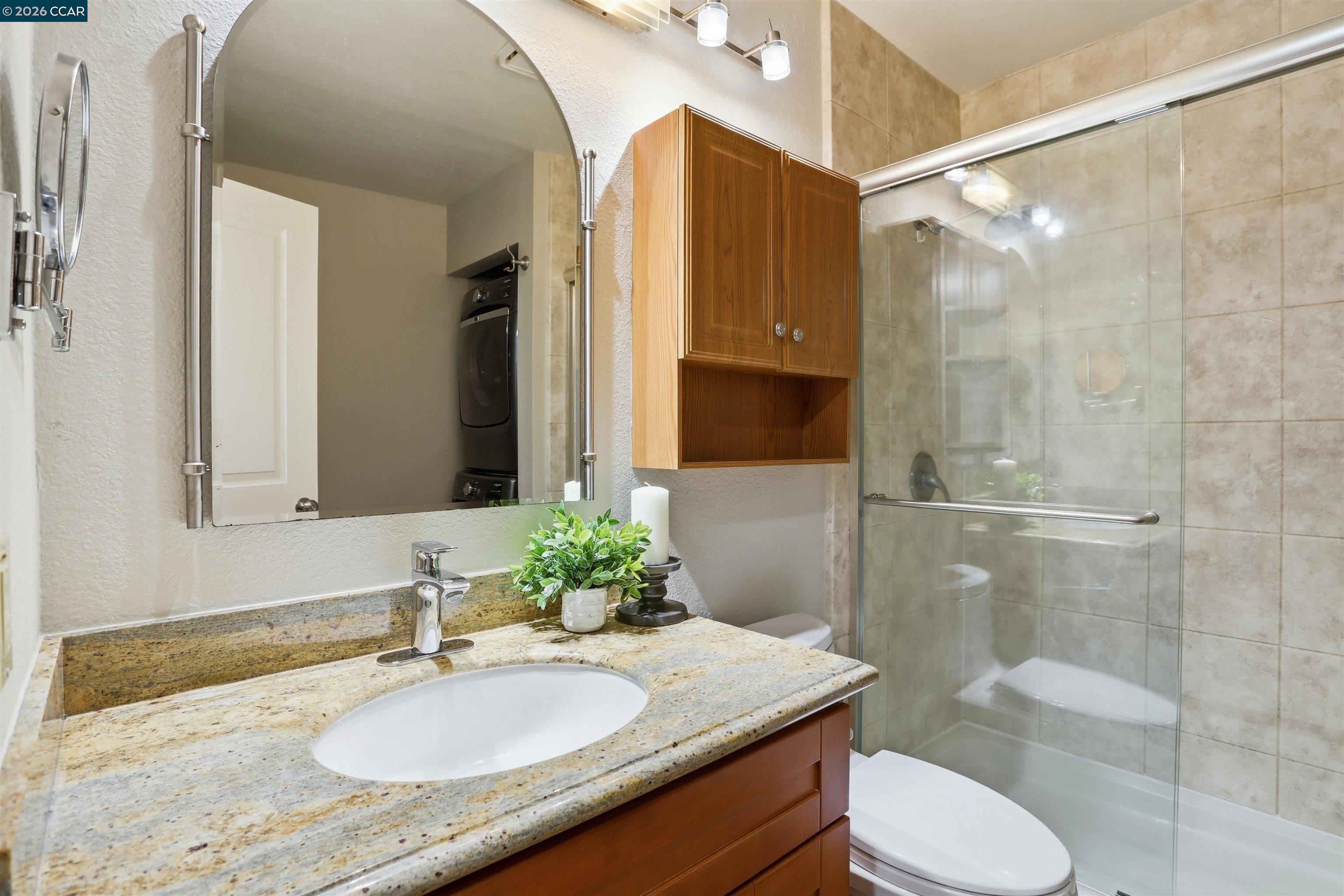 7020 Stagecoach Road, Unit G Dublin, CA 94568 - Photo 18 of 21 a bathroom with a granite countertop sink toilet and shower