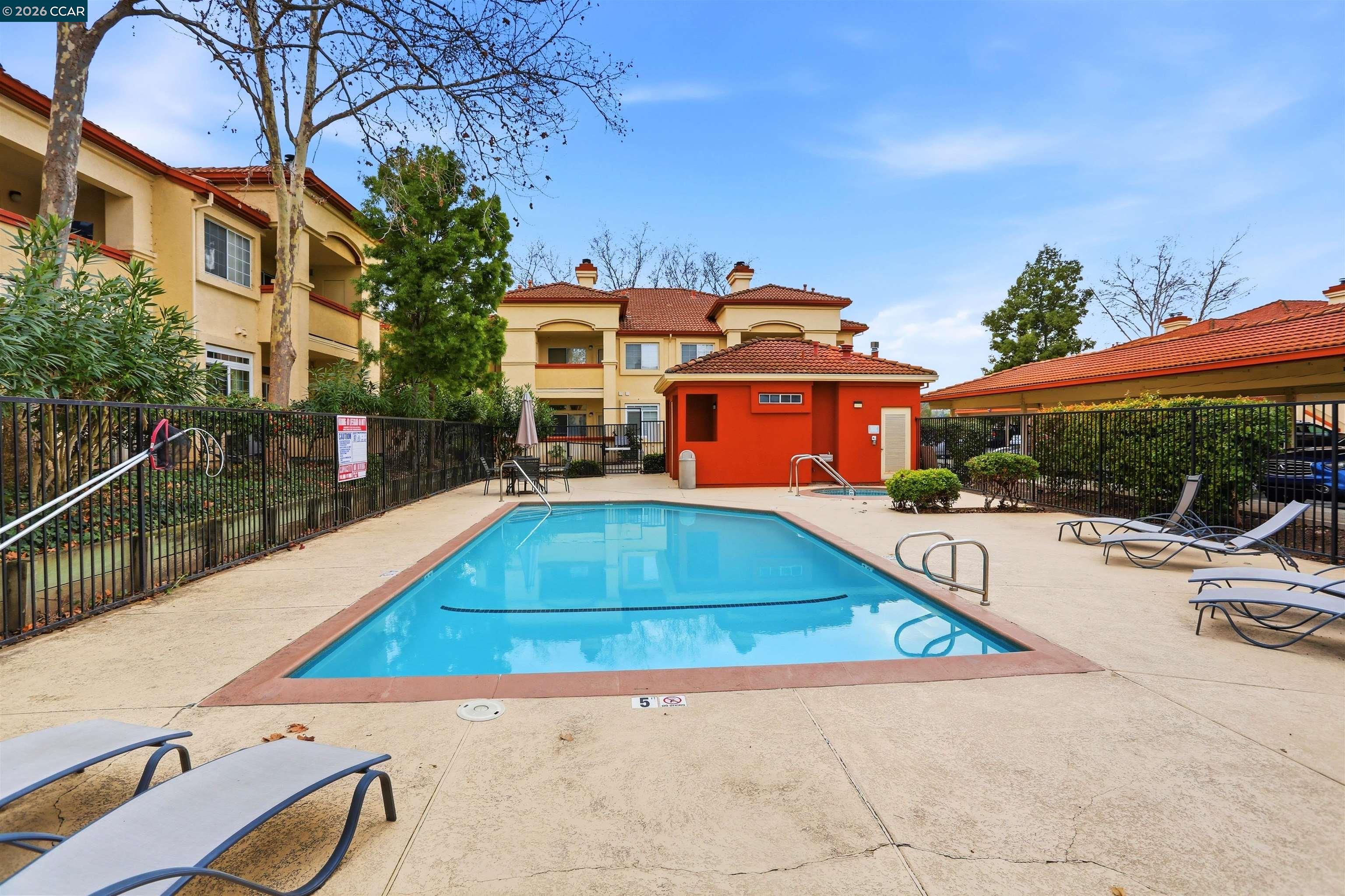 7020 Stagecoach Road, Unit G Dublin, CA 94568 - Photo 21 of 21 a swimming pool with outdoor seating and yard
