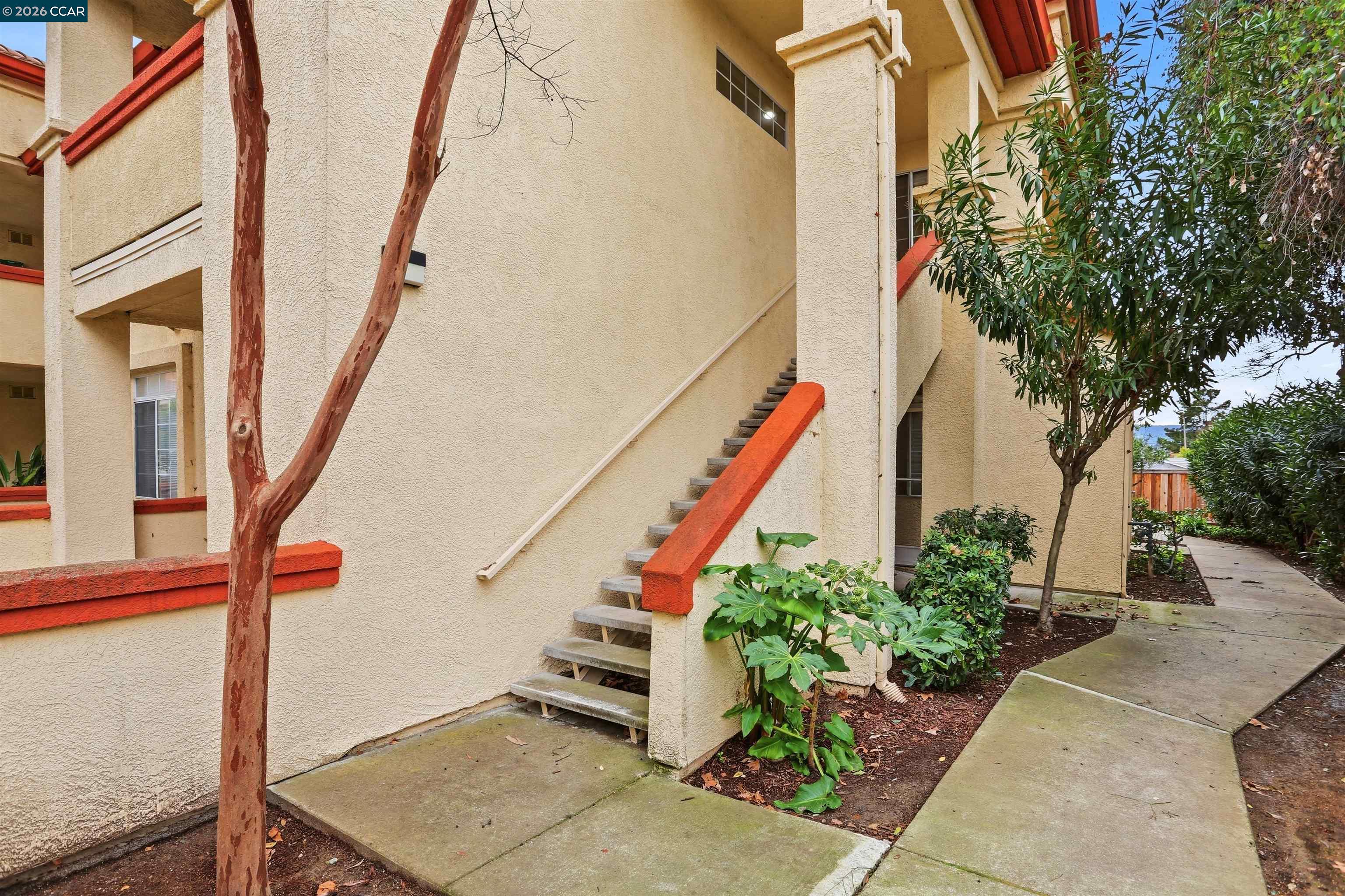 7020 Stagecoach Road, Unit G Dublin, CA 94568 - Photo 4 of 21 a balcony with flower plants and wooden fence