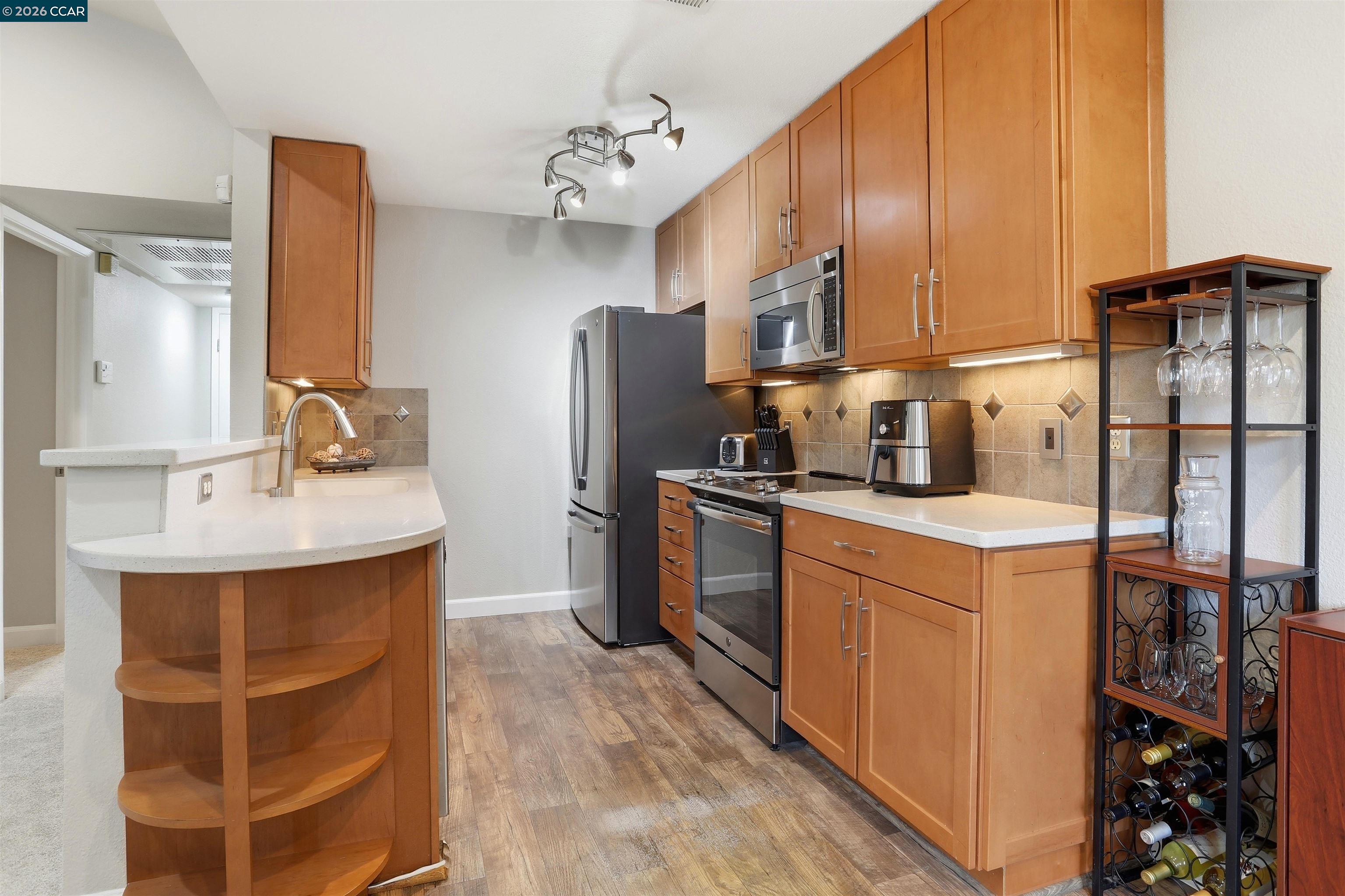 7020 Stagecoach Road, Unit G Dublin, CA 94568 - Photo 8 of 21 a kitchen with refrigerator a sink and cabinets