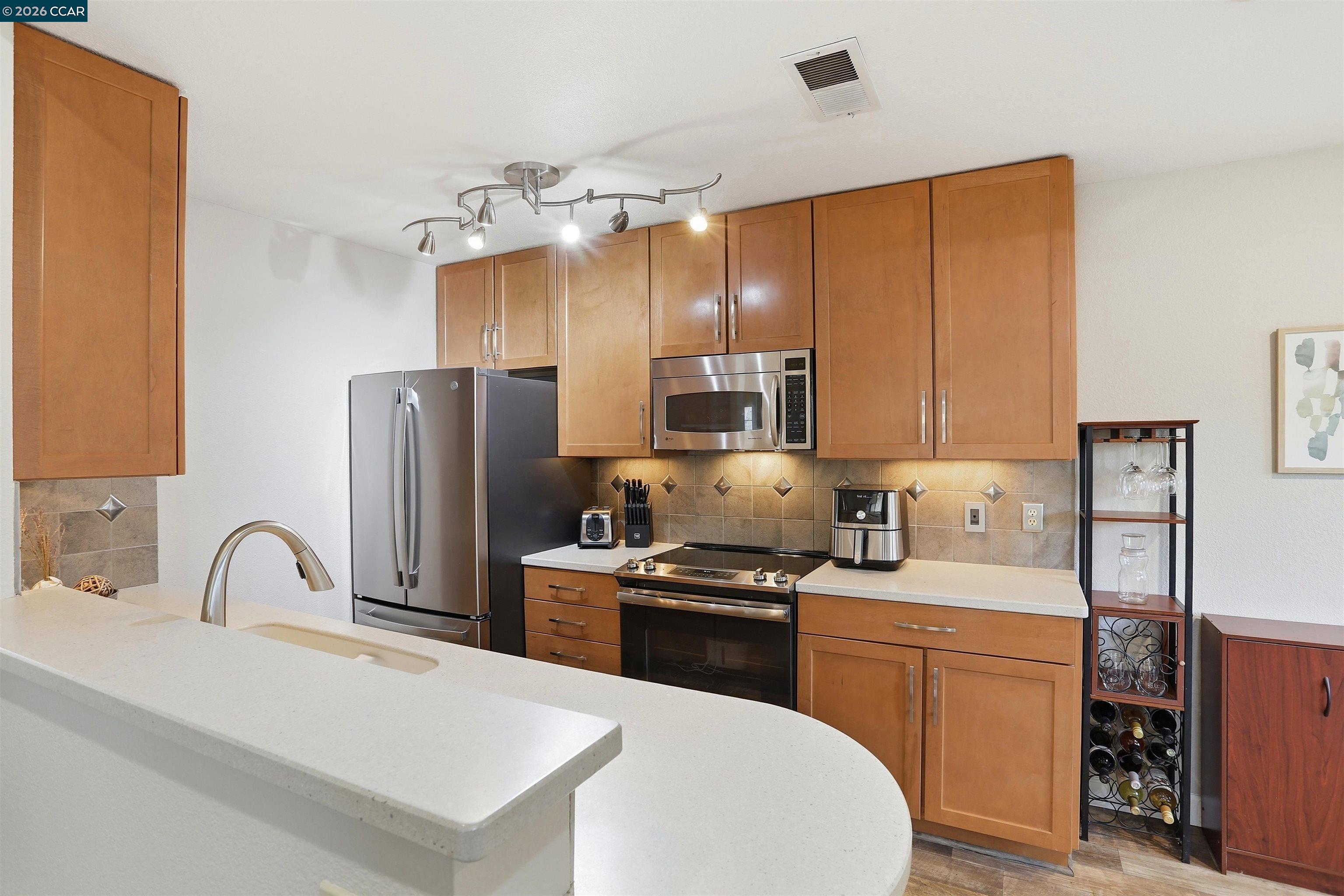 7020 Stagecoach Road, Unit G Dublin, CA 94568 - Photo 10 of 21 a kitchen with a sink appliances and cabinets