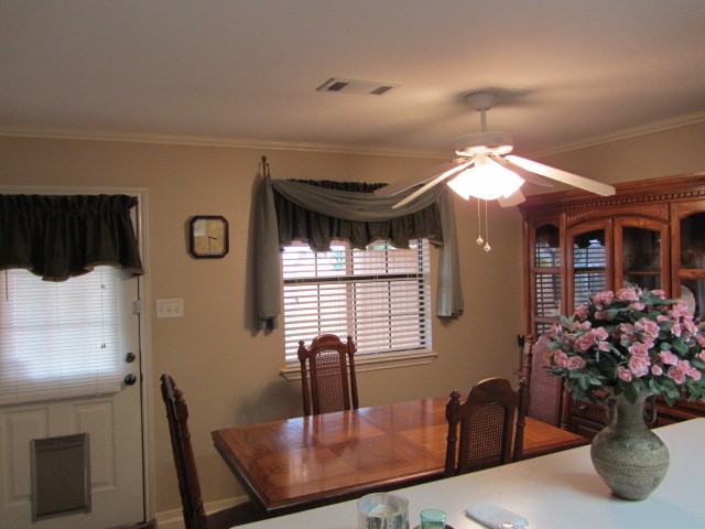 1914 20th Street Huntsville, TX 77340 - Photo 11 of 23 a view of a dining room with furniture and a chandelier