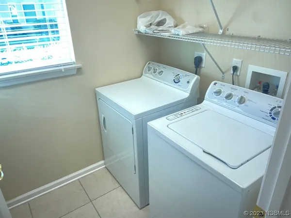a backyard of a house with yard table and chairs