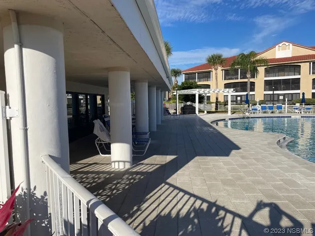 a view of a patio with swimming pool table and chairs