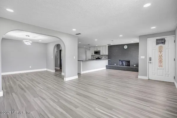 a view of kitchen living room with wooden floor