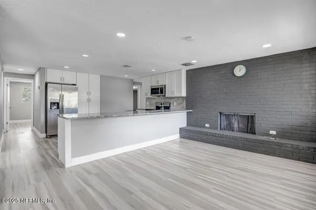 a view of kitchen with cabinets and wooden floor