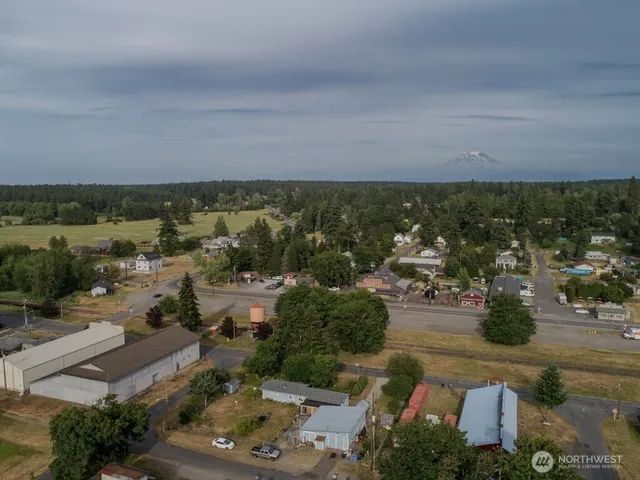 an aerial view of a house with yard swimming pool and lake view