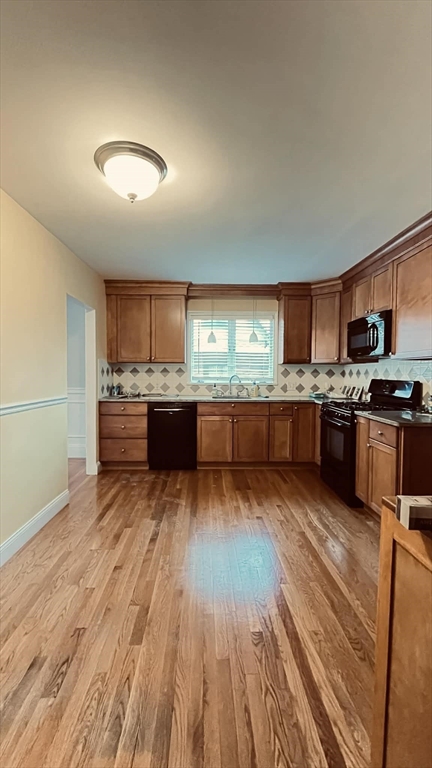 21 Lawrence Lane Belmont, MA 02478 - Photo 2 of 13 a kitchen with granite countertop stainless steel appliances and wooden cabinets