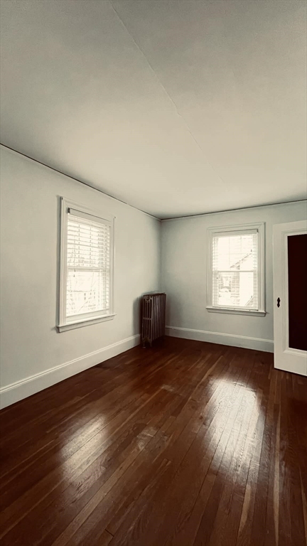 21 Lawrence Lane Belmont, MA 02478 - Photo 7 of 13 a view of an empty room with wooden floor and a window